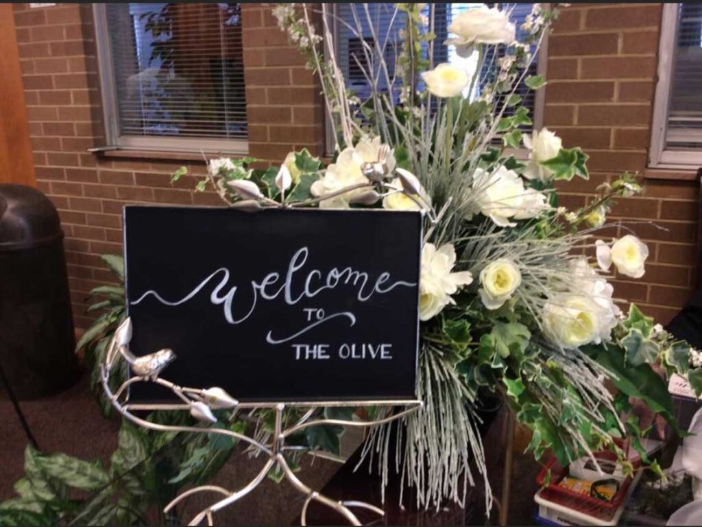 welcome sign with floral arrangement